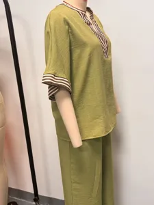 Detail view of women's casual olive green two-piece set with striped trim top and wide leg pants.