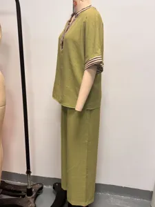 Green two-piece casual women's outfit featuring striped collar and stylish wide-leg pants.