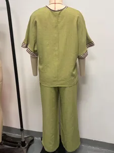 Back view details of the casual green two-piece outfit showing the sleeve striped trim and fit.