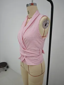 Detail view of pink white striped sleeveless wrap top, lapel collar, irregular hem style.
