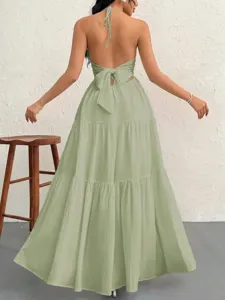 Backless halter neck tiered maxi dress in sage green, perfect for summer resort parties.