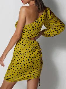 Close-up detail of the yellow animal print one-shoulder bodycon dress featuring stylish waist cutouts.