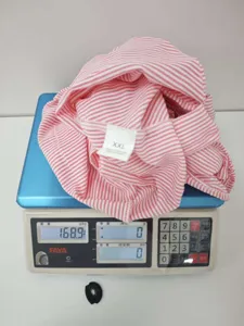 Detailed view of pink white striped fabric top with XXL size tag and weight inspection shot.