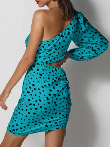 Turquoise one-shoulder bodycon mini dress with black spots and stylish waist cutouts.