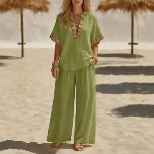 Casual green two-piece outfit featuring a V-neck top and wide-leg pants for women.