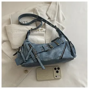 Detailed view of blue vintage motorcycle shoulder bag with metal buckles and zippers.