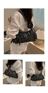 Black vintage punk motorcycle shoulder bag with multiple buckles and metal eyelets.