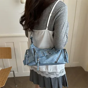 Retro motorcycle shoulder bag with multiple zippers and buckle straps, vintage blue faux leather.