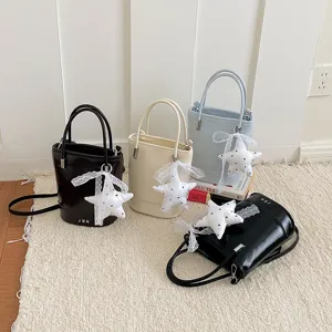 Detailed view of fashionable PU leather bucket bag with cute star charm, versatile design.