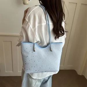 Detail view of the light blue star print tote bag, showcasing shoulder strap and texture.