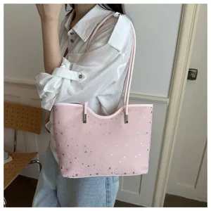 Detail view of the pink shoulder tote bag with silver star pattern, casual daily commute style.