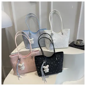 Detailed view of large capacity tote bag with star pattern and cute plush bear pendant.