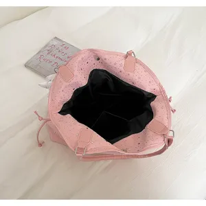 Detailed view of the pink large capacity tote bag with star patterns and black interior lining.