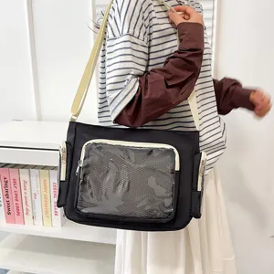 Black canvas messenger ita bag with clear window and crossbody strap for casual daily use.