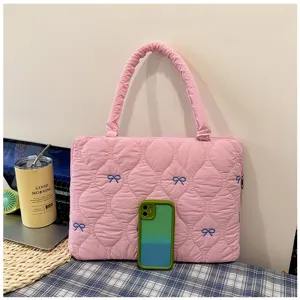 Pink quilted laptop sleeve with cute blue bow embroidery, portable bag for 13 inch devices.