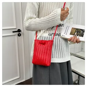 Sac bandoulière mini en cuir tressé rouge, vue détaillée élégante et accessoire compact.