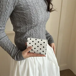 Close-up details of the chic polka dot clutch bag, ideal for daily commute and casual outfits.