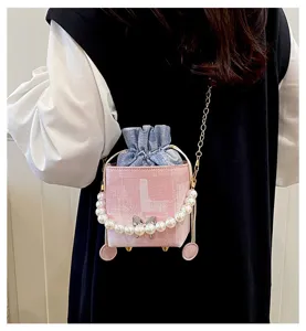 Pink box crossbody shoulder bag with pearl handle and denim pouch for stylish women