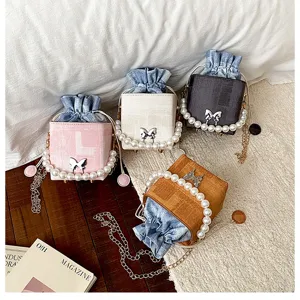 Chic stylish small square box handbag with pearl chain handle and denim pouch for women.