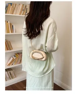 Detailed view of trendy women shoulder chain bag with unique metal loop buckle design.