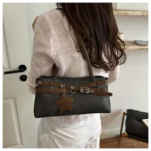 Retro Y2K style dark grey shoulder bag with brown straps, metal buckles and star pendant.