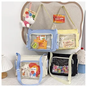 Canvas ita bag detail showing transparent front pocket, messenger style and spacious storage.