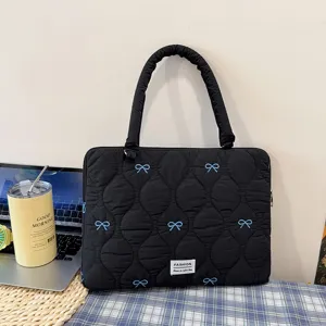 Black quilted laptop sleeve with blue bows, cute handle bag for daily office and school use.