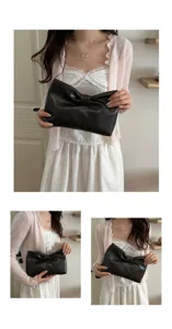 Detailed view of stylish black clutch bag with bowknot design for elegant daily looks.