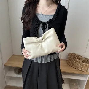 Chic minimalist faux leather clutch bag with stylish bow design for casual daily wear.