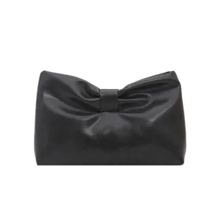 Black leather bow clutch bag minimalist French style elegant casual chic evening purse.