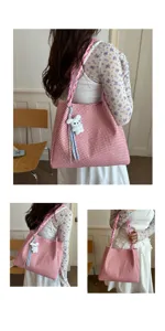 Detailed view of pink woven shoulder tote bag with cute plush pendant and braided strap.