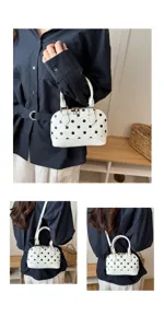 White polka dot dome handbag detail view, stylish shoulder bag with top handle and zipper.