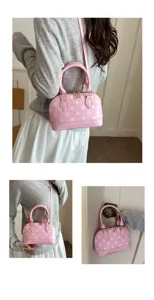 Detailed view of the stylish pink polka dot dome handbag, perfect for shoulder and crossbody wear.