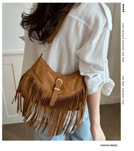 Detailed shot of brown suede fringe shoulder bag with metallic buckle, stylish commute accessory.