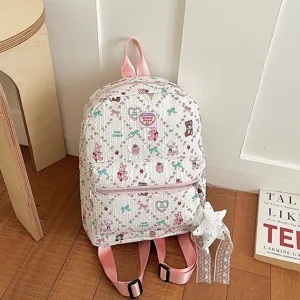 Cute cartoon print student backpack detail shot, white fabric with pink straps for daily use.