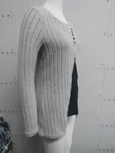 Close-up side view of a grey ribbed faux-two-piece long sleeve top displayed on a mannequin.