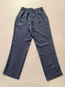 Rear view detail of men's loose casual straight-leg dress trousers in a navy blue finish