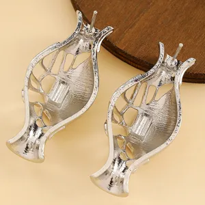 Macro view of the detailed silver metallic vase-shaped artistic brooches with hollow-out design