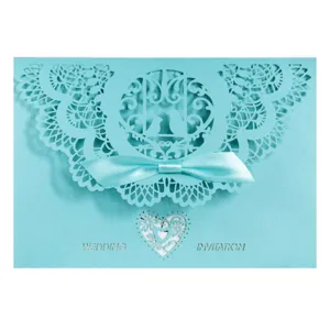 Elegant laser-cut wedding invitation card in tiffany blue with satin ribbon bow and lace