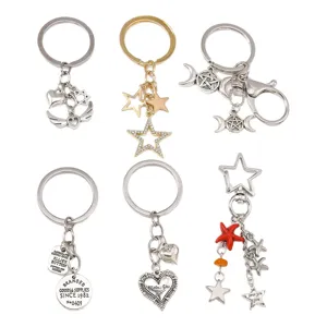 Set of diverse fashion keychains with heart, star, and moon charms on white background.