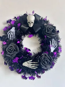 Détail d'une couronne d'Halloween avec roses noires, mains de squelette et chauves-souris mauves.