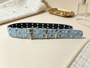 Light blue denim punk belt featuring star grommets and double prong buckle for jeans