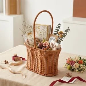 Close-up of a woven basket filled with tea, snacks, and fresh fruits on a linen table.