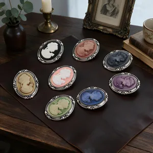 Detailed view of eight vintage Cameo portrait brooches in various elegant colors.