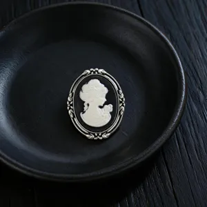 Close-up of vintage relief cameo brooch with elegant lady silhouette detail