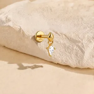 Close-up macro detail of S925 gold cartilage piercing stud with dangling diamond charm