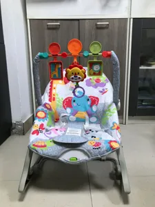 Detailed view of a multi-functional baby rocker featuring colorful animal patterns