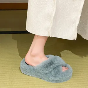Detailed view of soft blue fuzzy cross-strap slippers with thick soles for cozy home wear