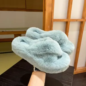 Side view showing the thick platform and soft furry texture of mint green home slippers