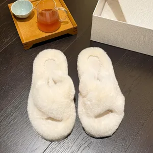 Macro detail of cream fuzzy slippers with cross-strap design for indoor comfort